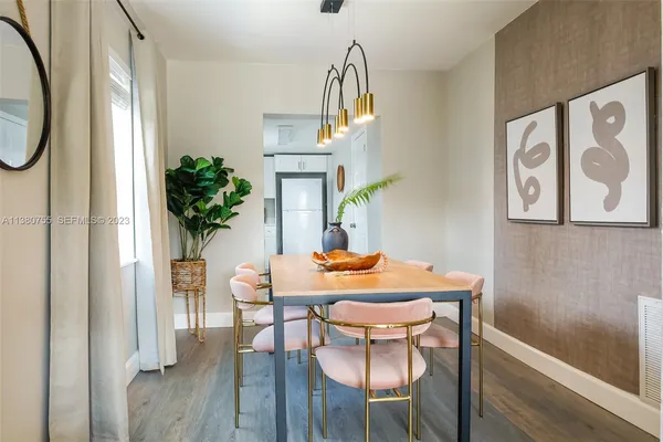 a view of a dining room with furniture window and wooden floor