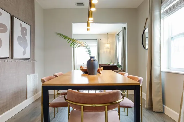 a view of a dining room with furniture window and wooden floor