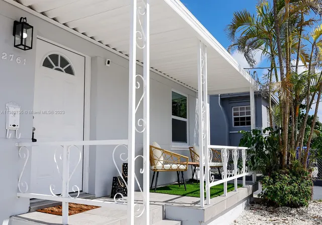 a view of front door and potted plants