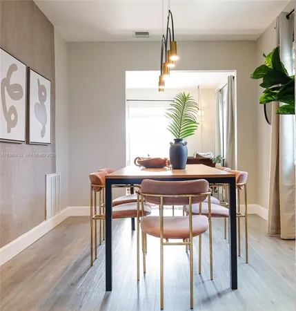 a dining room table with chairs and window