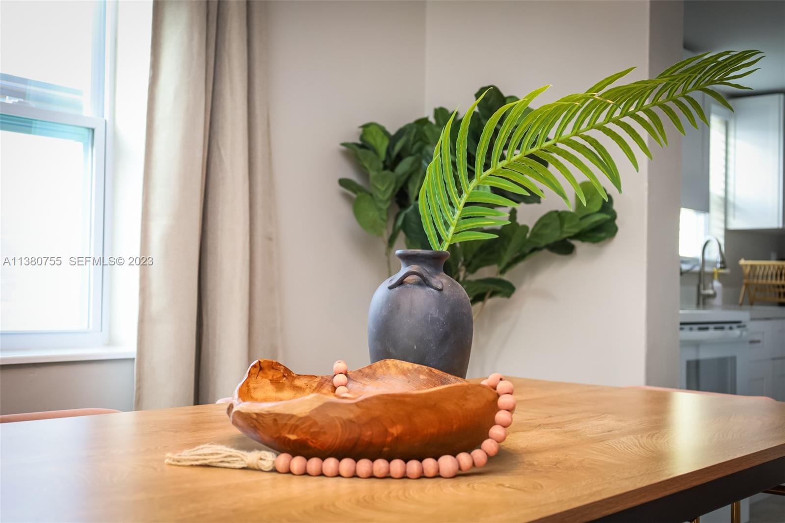 2761 Southwest 33rd Avenue, Unit 1 Miami, FL 33133 - Photo 9 of 46 a view of a dining table with a potted plant