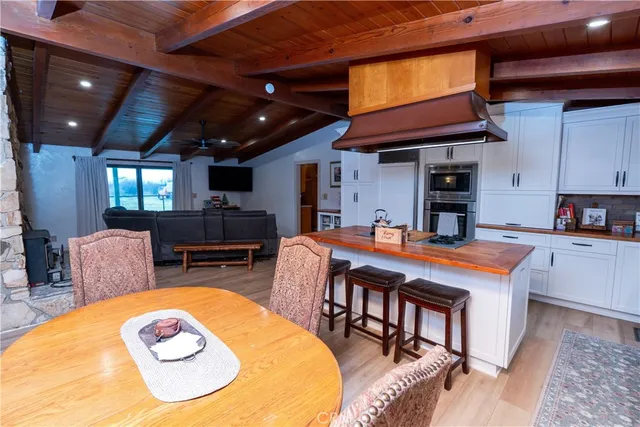 a kitchen with stainless steel appliances a refrigerator a sink and wooden floors