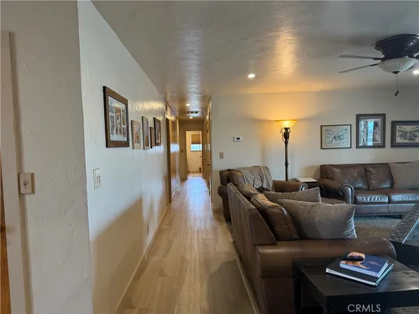 a bedroom with a bed a television and a couch