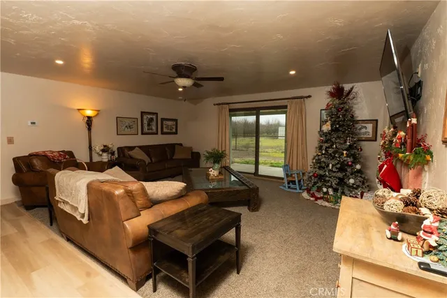 a living room with furniture a window and a flat screen tv