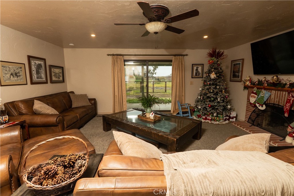 25565 Road 13 Chowchilla, CA 93610 - Photo 20 of 64 a living room with furniture a window and a flat screen tv