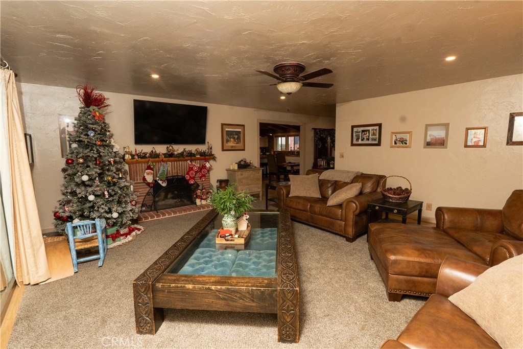 25565 Road 13 Chowchilla, CA 93610 - Photo 21 of 64 a living room with furniture and a flat screen tv