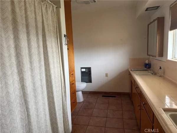 a view of a workspace with furniture and wooden floor