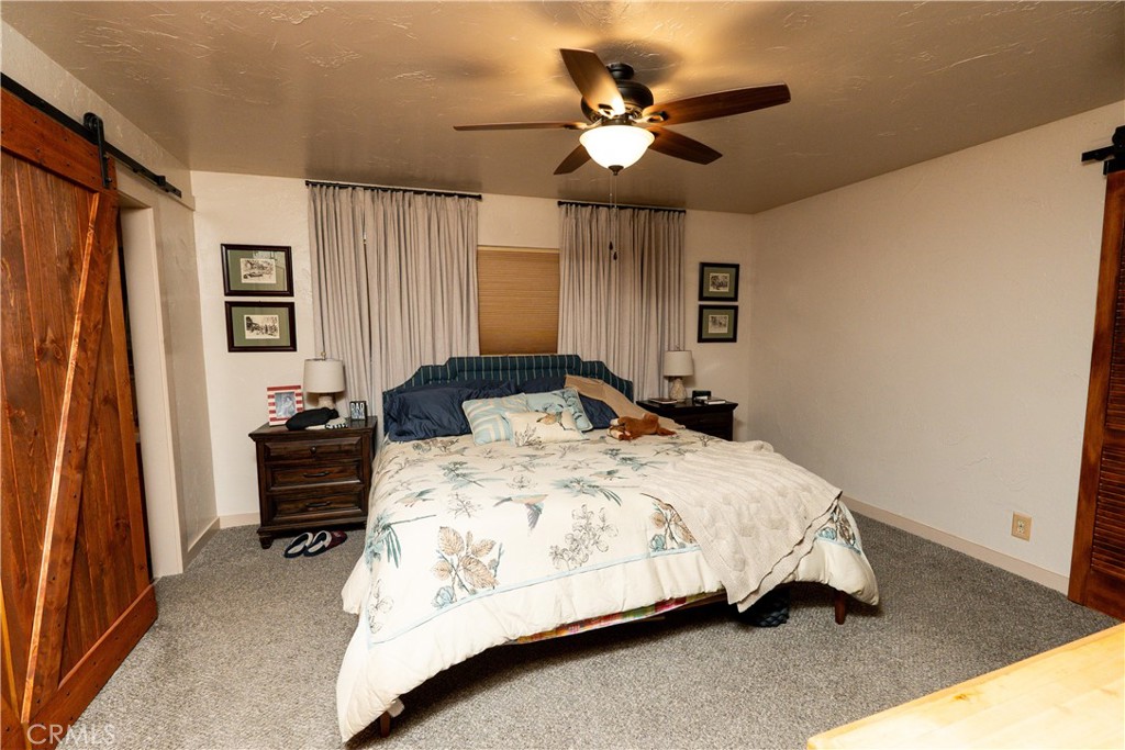 25565 Road 13 Chowchilla, CA 93610 - Photo 28 of 64 a bedroom with a bed and a chandelier