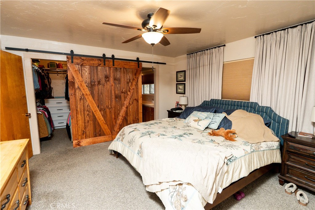 25565 Road 13 Chowchilla, CA 93610 - Photo 29 of 64 a bedroom with a bed and a walk in closet