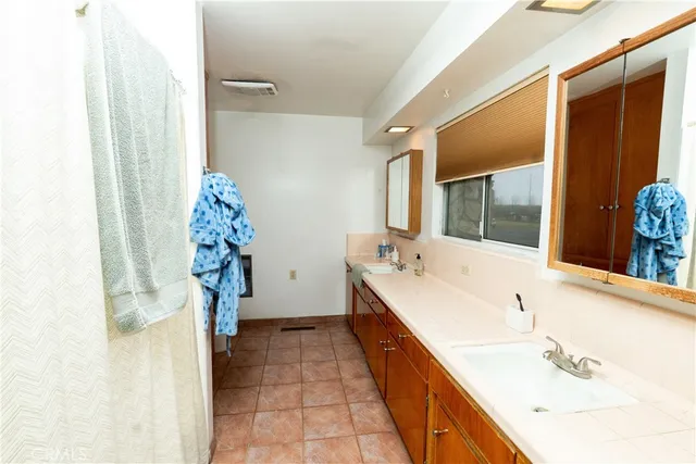 a bedroom with a bed and a flat tv screen on the dresser