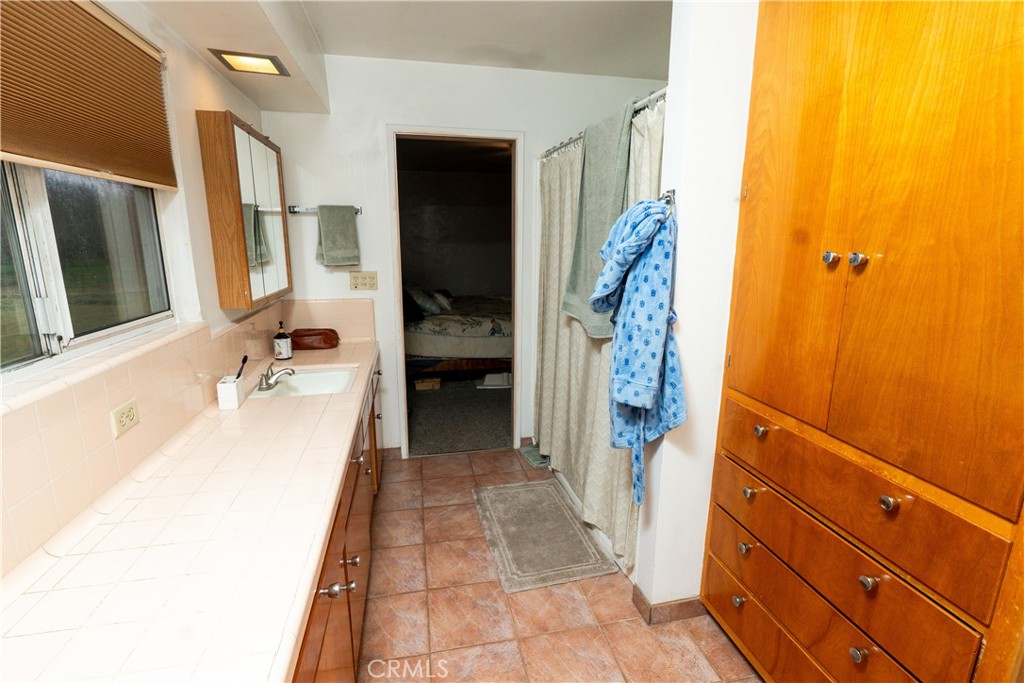 25565 Road 13 Chowchilla, CA 93610 - Photo 32 of 64 a bathroom with a tub sink and mirror