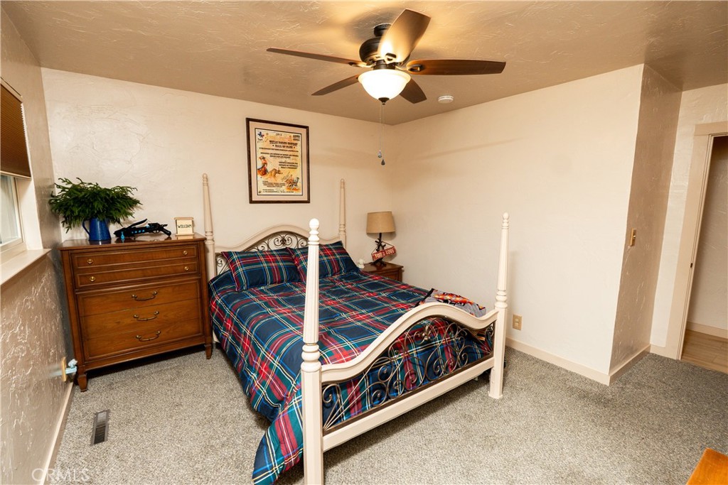 25565 Road 13 Chowchilla, CA 93610 - Photo 35 of 64 a bedroom with bed and a flat screen tv