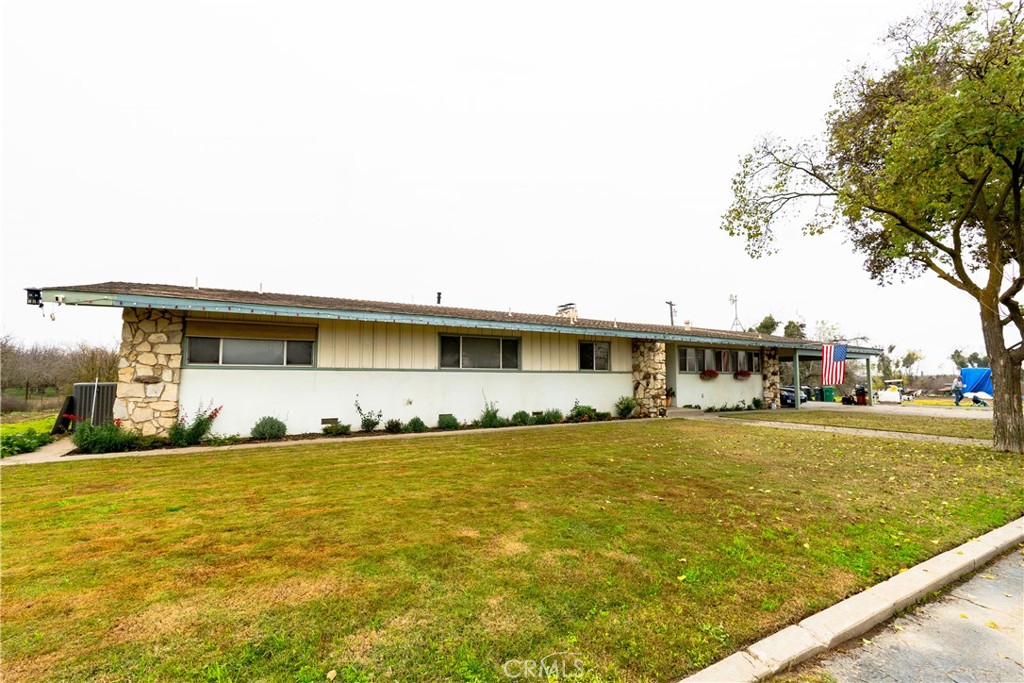 25565 Road 13 Chowchilla, CA 93610 - Photo 4 of 64 a front view of a house with a yard