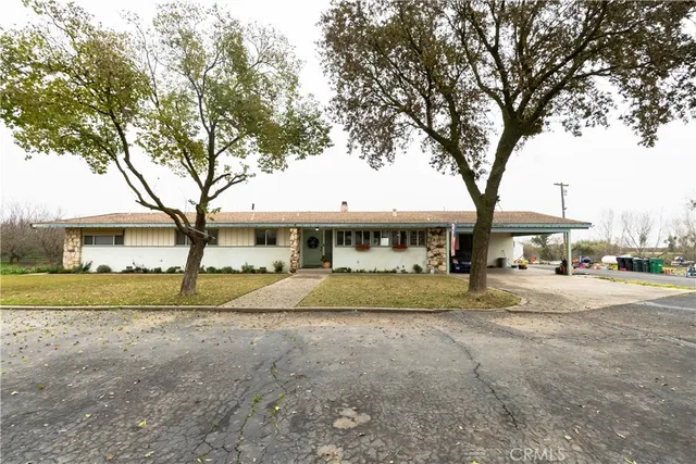 a view of a town with large trees and a small barn