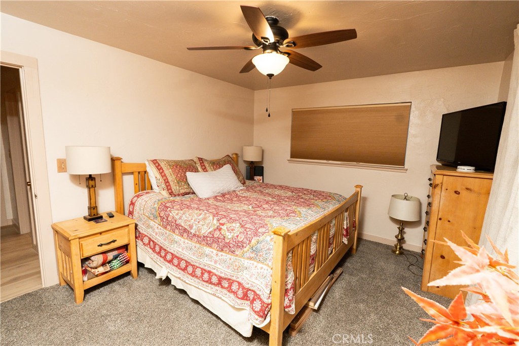 25565 Road 13 Chowchilla, CA 93610 - Photo 43 of 64 a spacious bedroom with a bed and a flat screen tv