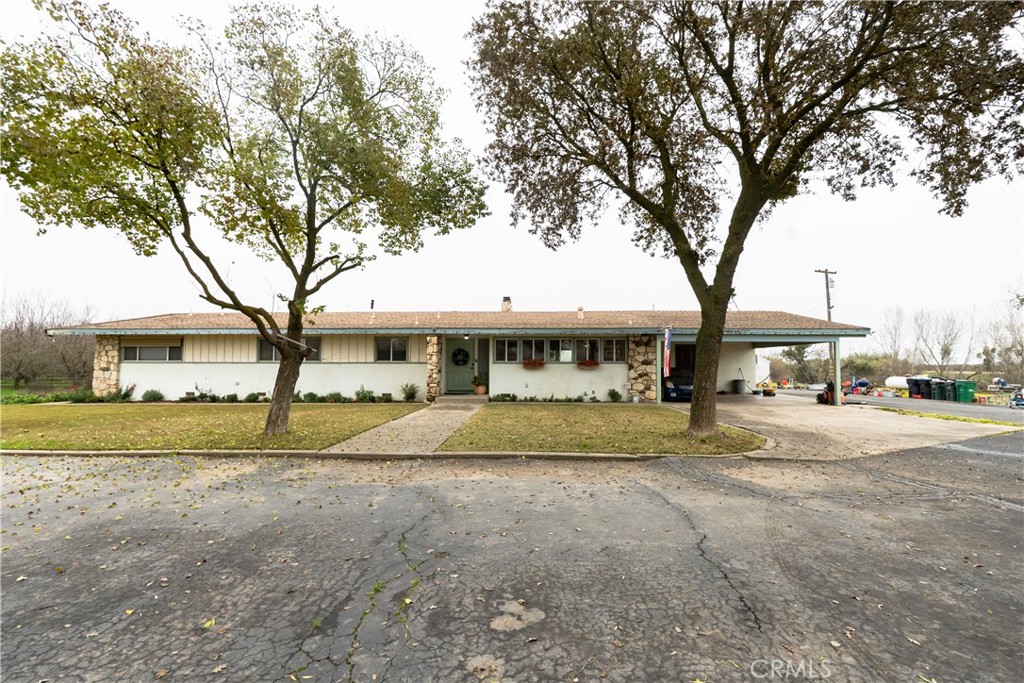 25565 Road 13 Chowchilla, CA 93610 - Photo 5 of 64 a big house with trees in front of it
