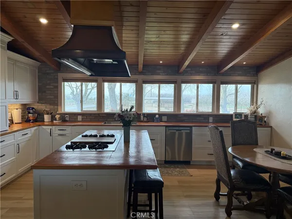 a living room with furniture a dining table and chairs with wooden floor