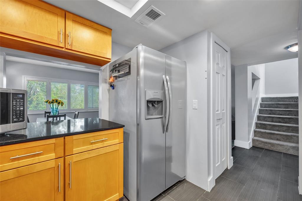 5377 Vineland Road, Unit 1D Orlando, FL 32811 - Photo 11 of 25 a bathroom with a granite countertop sink and a mirror