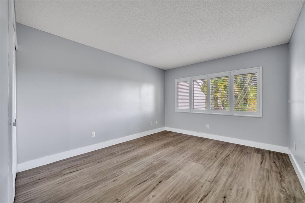 5377 Vineland Road, Unit 1D Orlando, FL 32811 - Photo 16 of 25 an empty room with wooden floor and windows