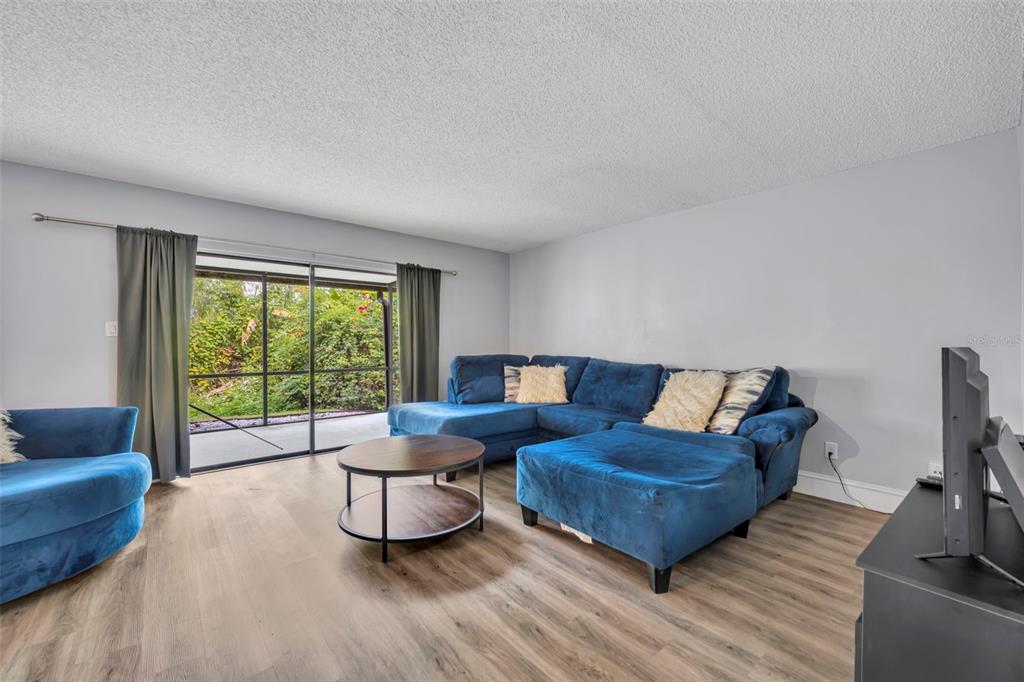 5377 Vineland Road, Unit 1D Orlando, FL 32811 - Photo 7 of 25 a living room with furniture and a large window