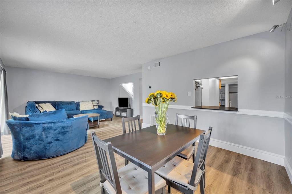 5377 Vineland Road, Unit 1D Orlando, FL 32811 - Photo 10 of 25 a dining room with furniture and wooden floor