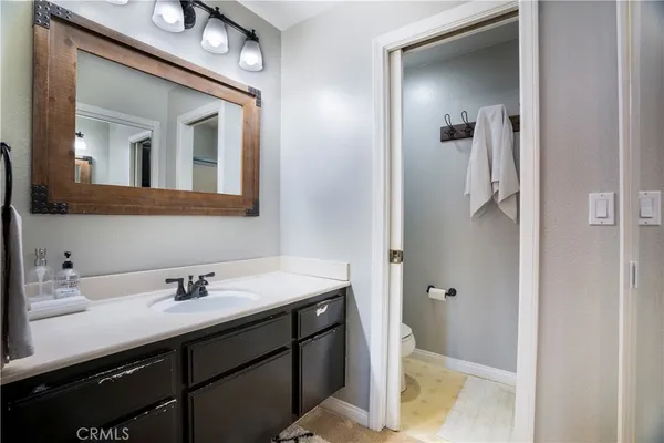 a bathroom with a sink vanity and mirror