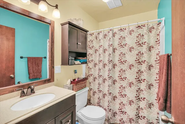 a bed room with a bed and a painting on the wall