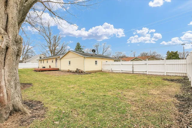 a view of a house with a yard and garage