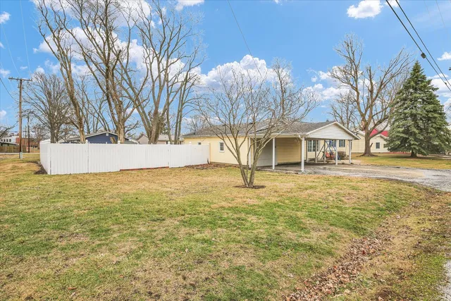 a view of a house with a backyard and a garage