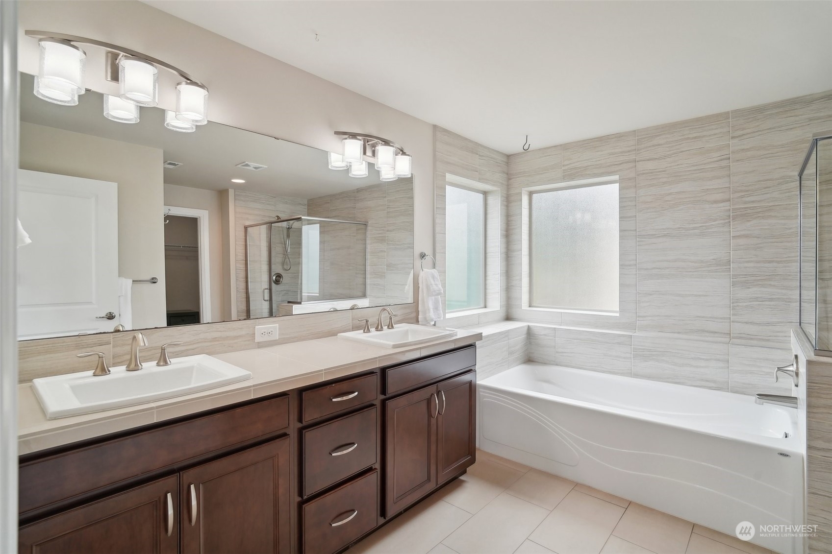 4111 Strumme Road Bothell, WA 98012 - Photo 19 of 39 a bathroom with a tub double vanity sink and mirror