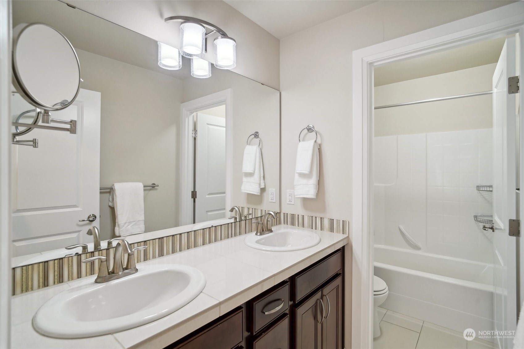 4111 Strumme Road Bothell, WA 98012 - Photo 27 of 39 a bathroom with a granite countertop sink a toilet and a mirror
