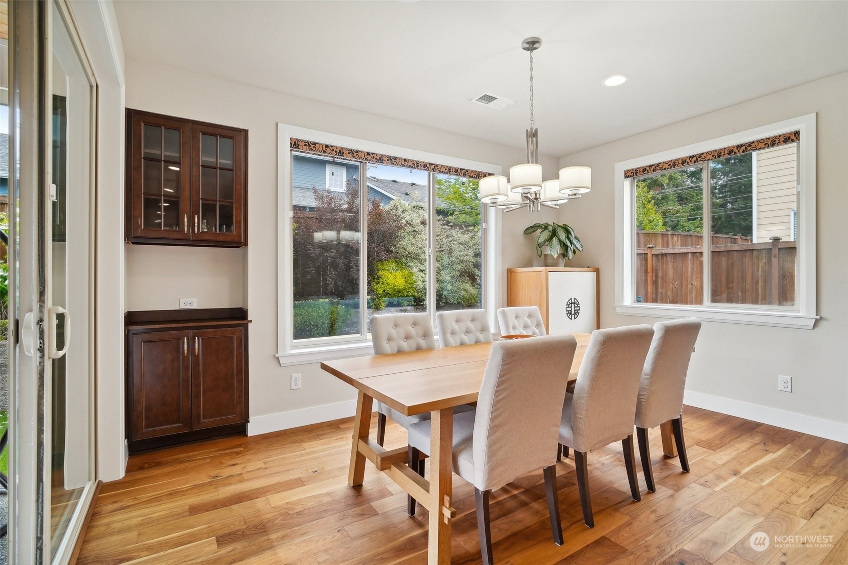 4111 Strumme Road Bothell, WA 98012 - Photo 9 of 39 a view of a dining room with furniture window and wooden floor