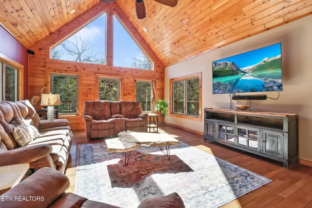 a living room with furniture a rug and a flat screen tv