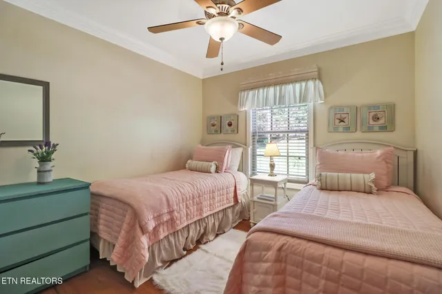 a bedroom with two beds and a window