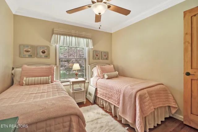 a bedroom with double bed and a chandelier