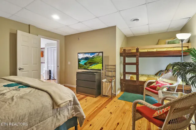 a bedroom with a bed and a tv