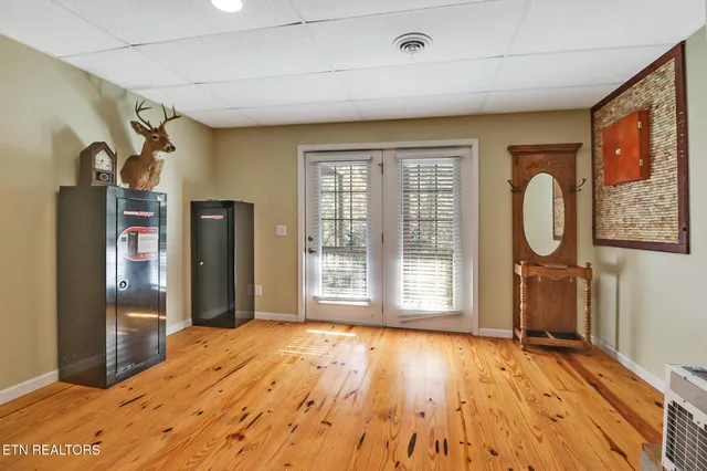 a view of a room with wooden floor and windows