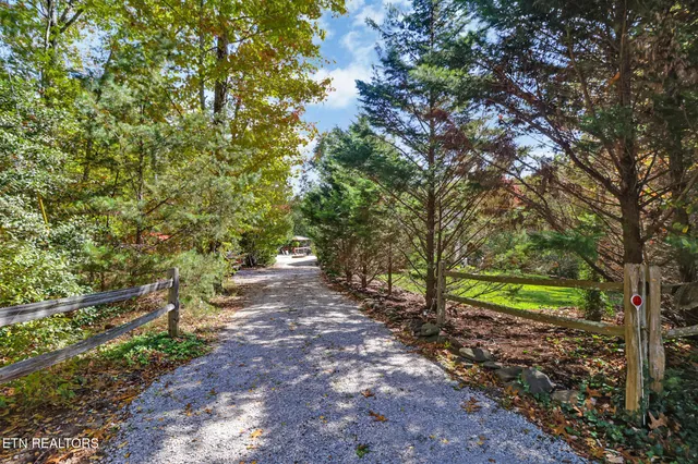 an outdoor sitting area with couch and wooden floor