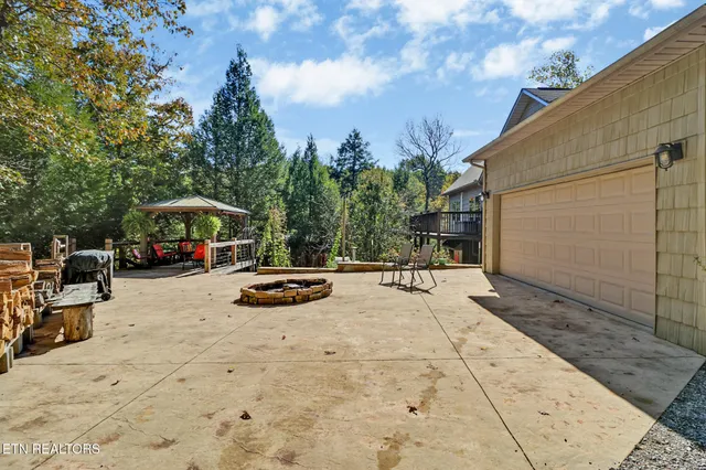 a view of a house with large trees