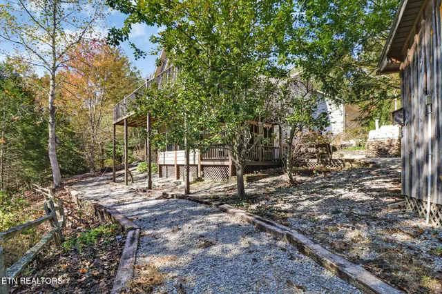 a view of a wooden bench in front of house