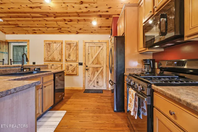 a kitchen with stainless steel appliances granite countertop a stove and a refrigerator