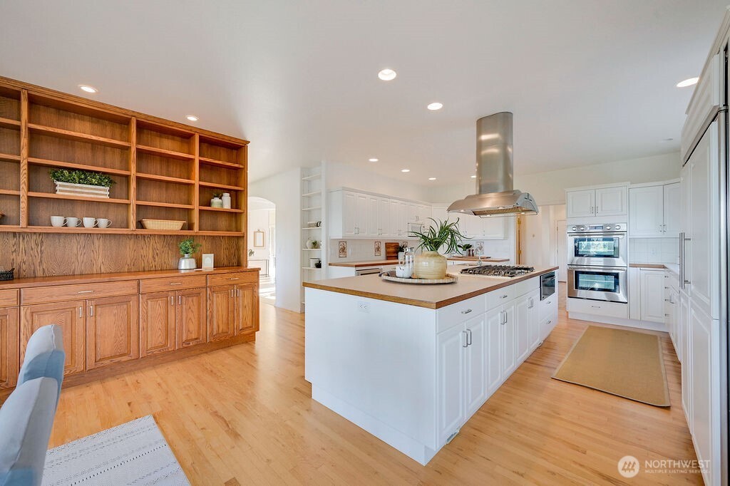 275404 Highway 101 Sequim, WA 98382 - Photo 18 of 40 a kitchen with stainless steel appliances granite countertop a sink stove and wooden cabinets