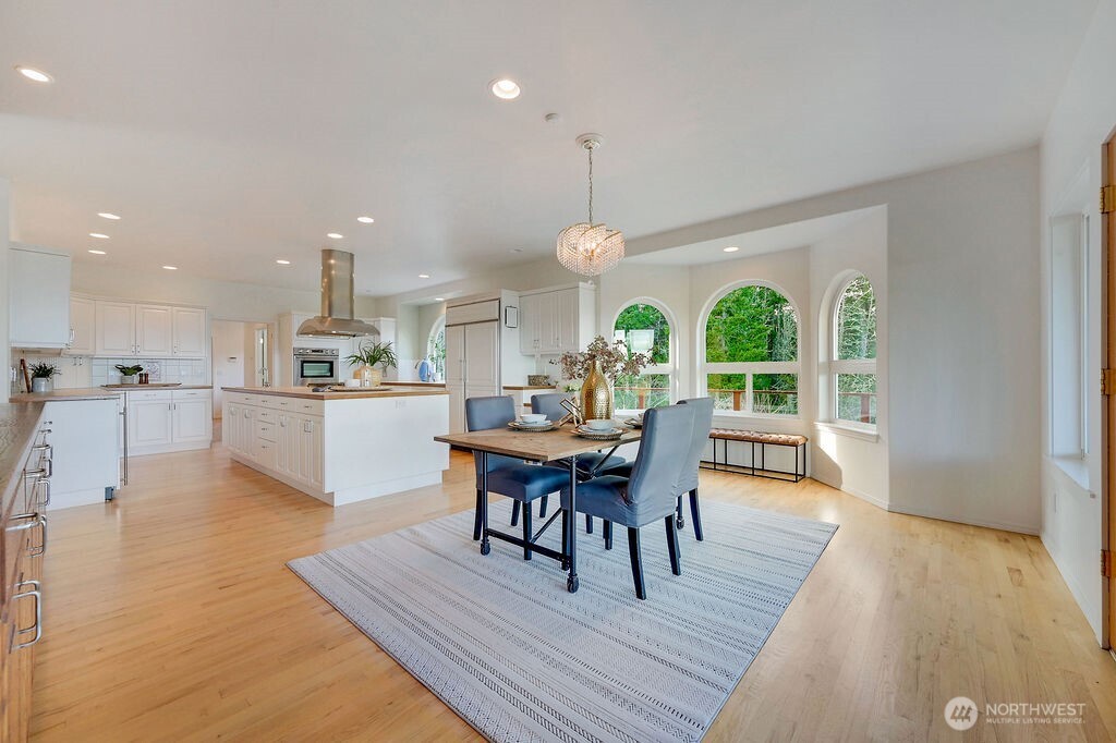 275404 Highway 101 Sequim, WA 98382 - Photo 23 of 40 a view of a dining room with furniture window and wooden floor