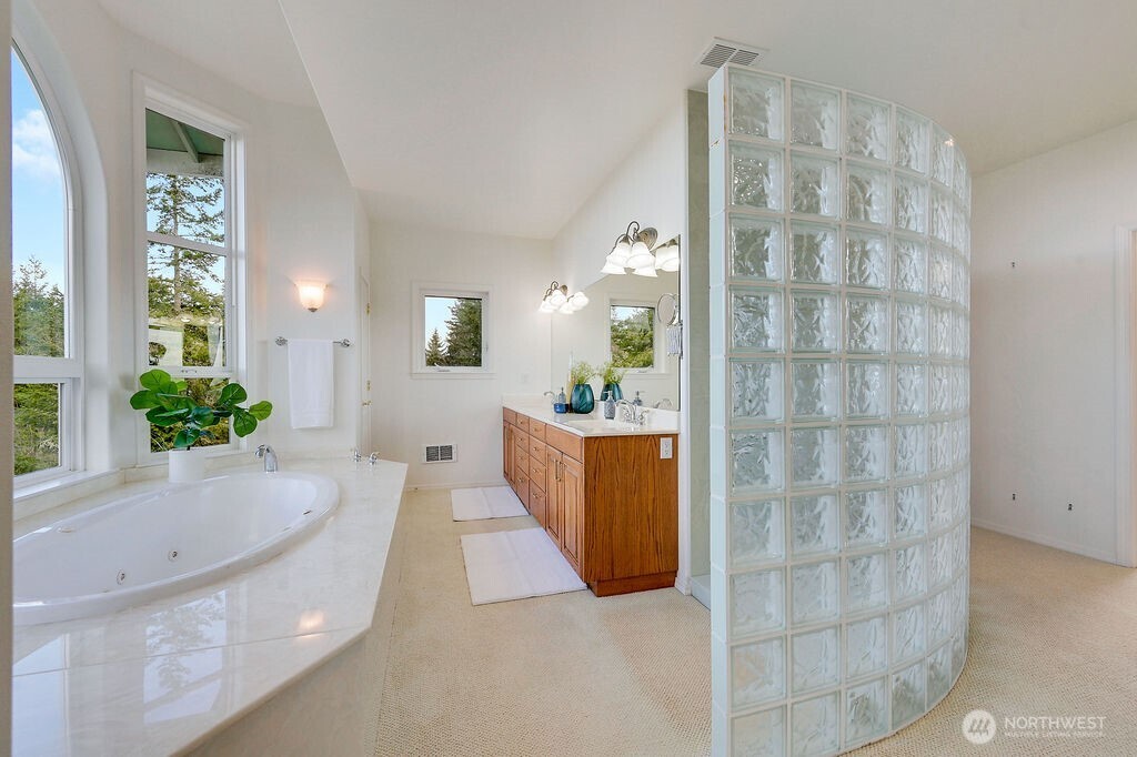 275404 Highway 101 Sequim, WA 98382 - Photo 28 of 40 a bathroom with a tub shower and sink