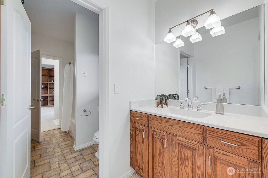 275404 Highway 101 Sequim, WA 98382 - Photo 32 of 40 a bathroom with a sink a light fixture and a mirror