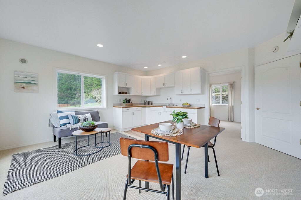 275404 Highway 101 Sequim, WA 98382 - Photo 36 of 40 a kitchen with a dining table chairs and window