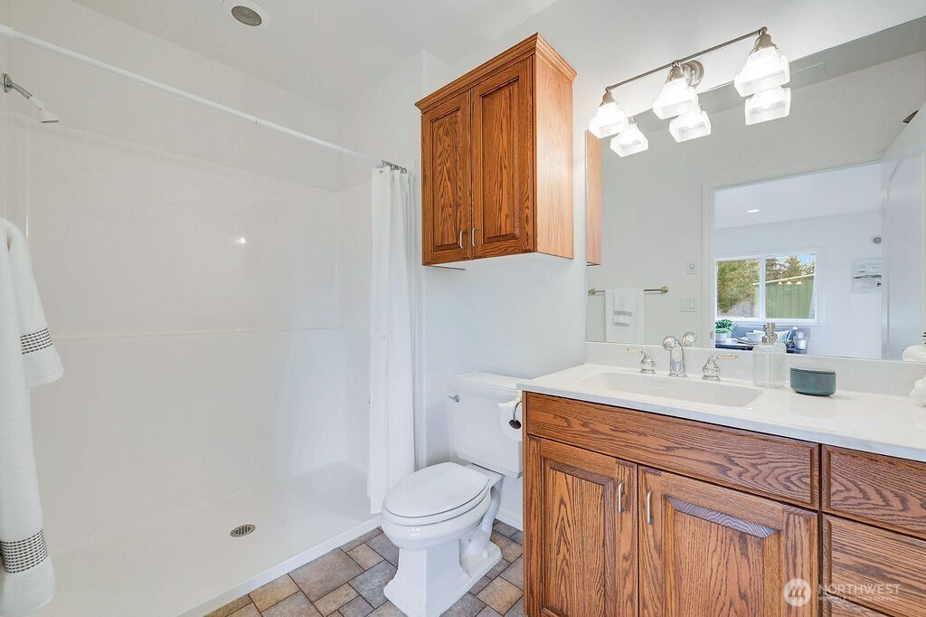 275404 Highway 101 Sequim, WA 98382 - Photo 38 of 40 a bathroom with a sink a toilet and a mirror