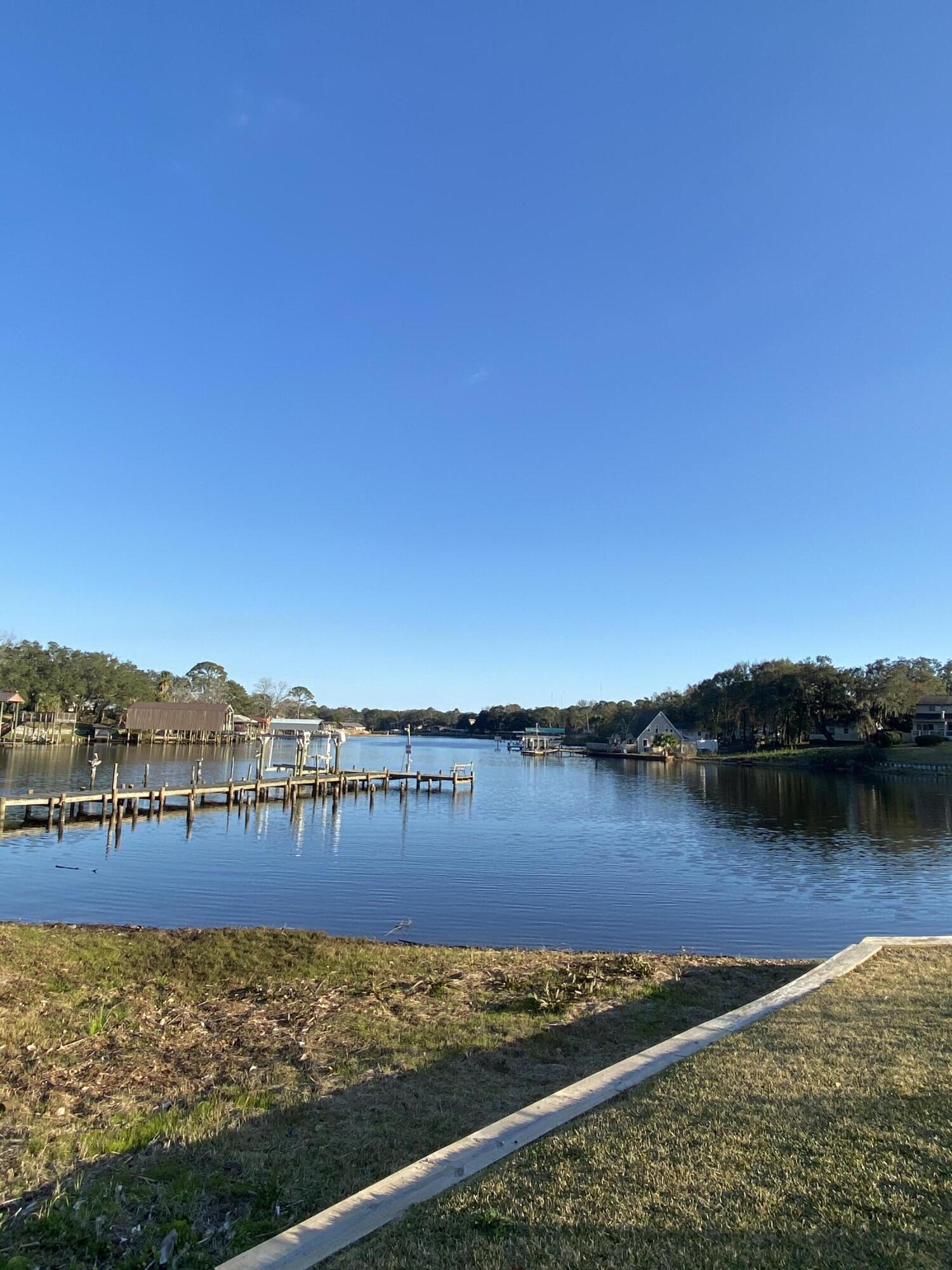 210 Pelham Road, Unit 107C Fort Walton Beach, FL 32547 - Photo 15 of 17 a view of a lake with houses in the background