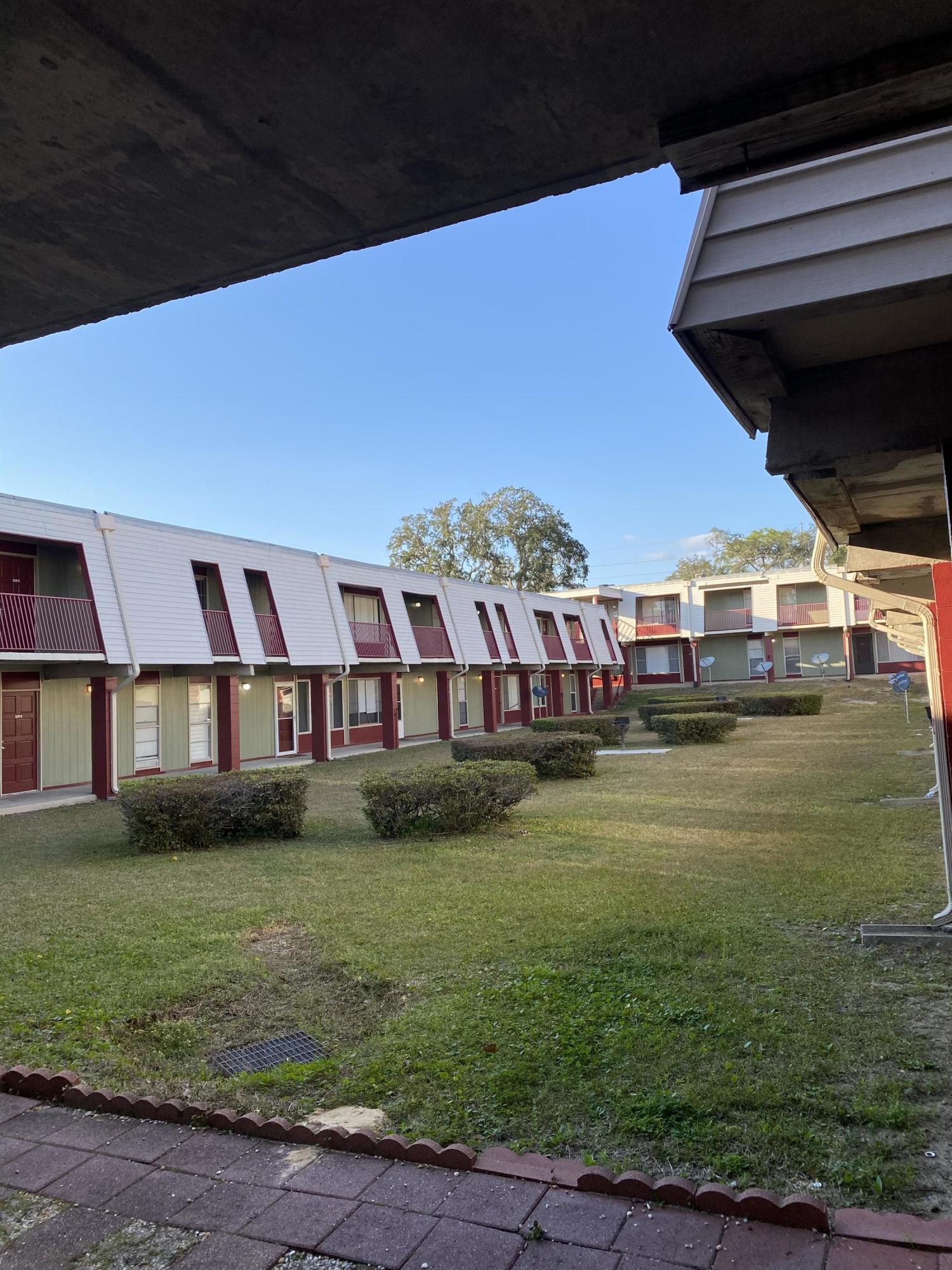 210 Pelham Road, Unit 107C Fort Walton Beach, FL 32547 - Photo 16 of 17 a front view of house with yard and green space