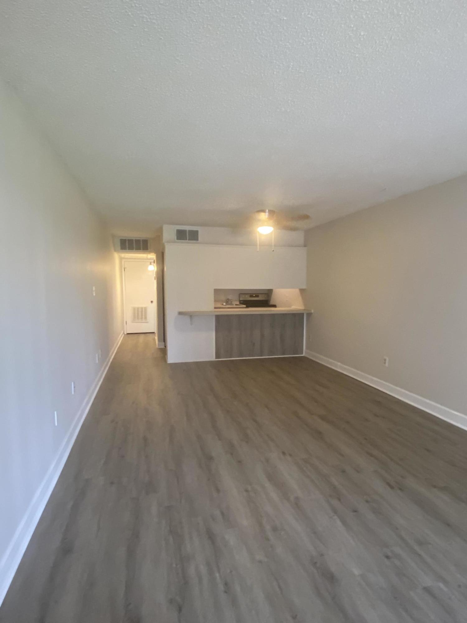 210 Pelham Road, Unit 107C Fort Walton Beach, FL 32547 - Photo 2 of 17 a view of empty room with wooden floor